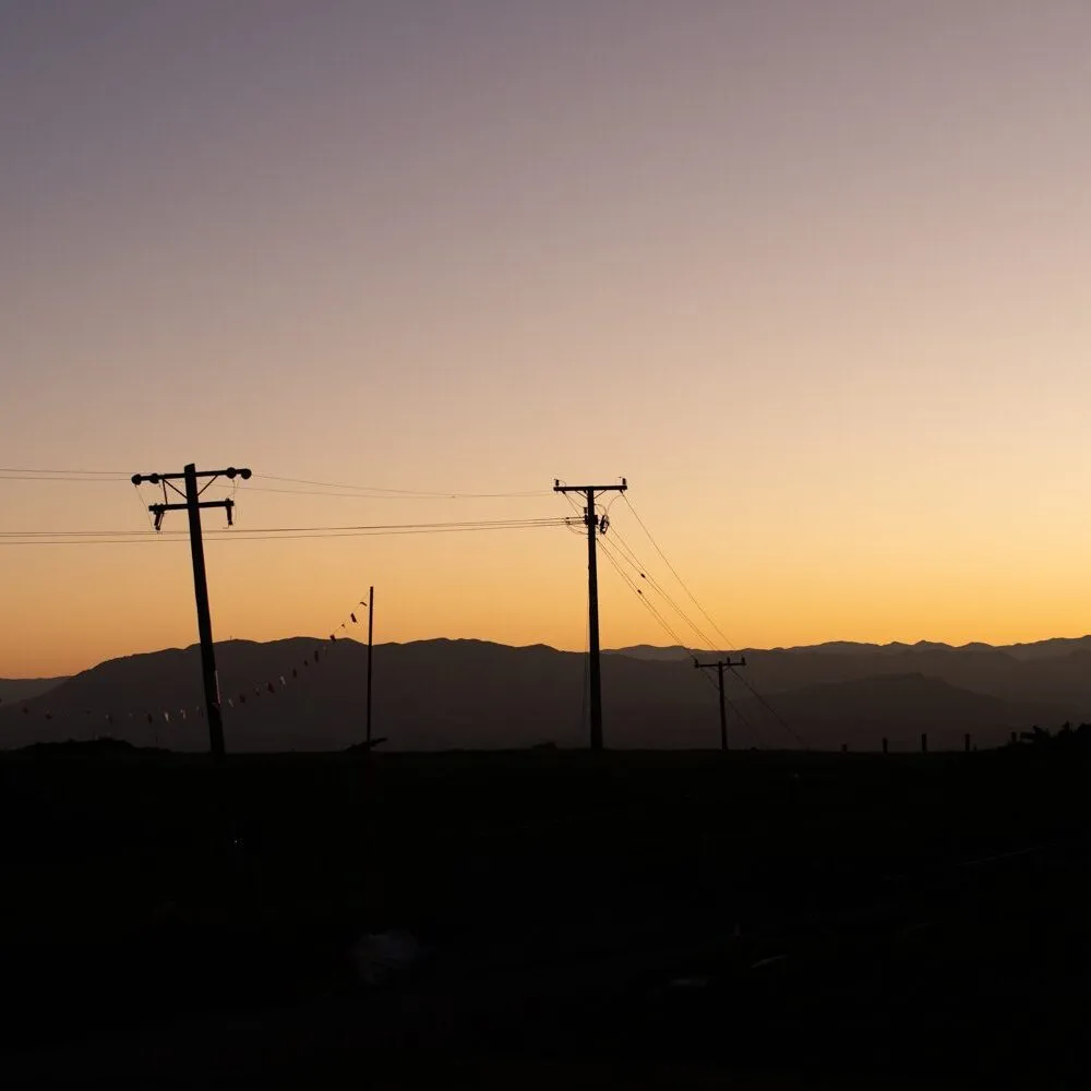 Power lines against a sunset