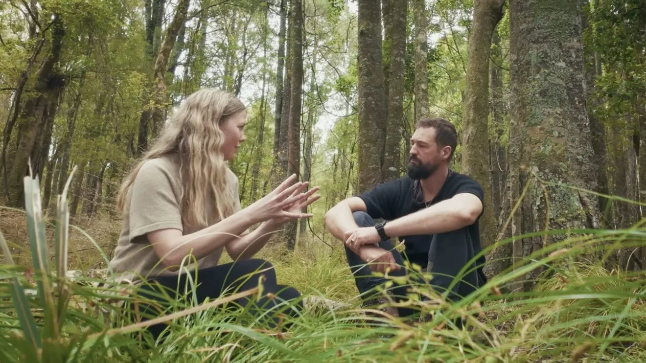 Two people in conversation in a native forest